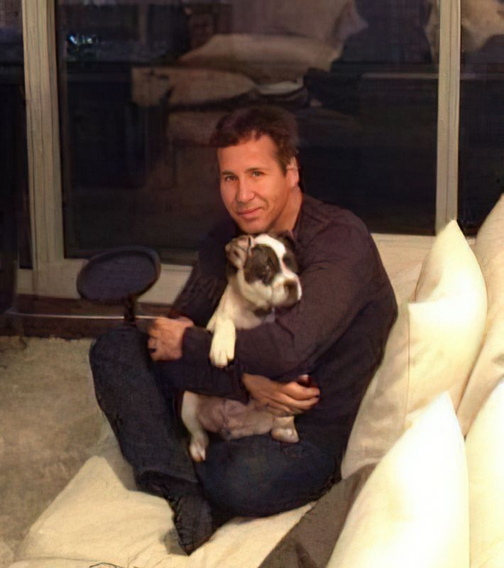 Ron Thomas at home with a rescued puppy